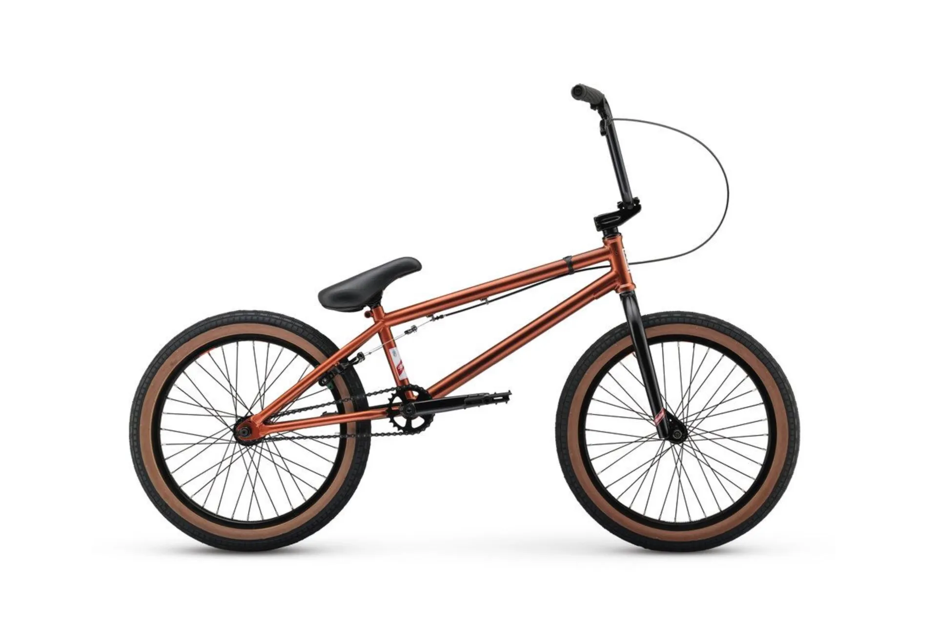 A copper BMX bike with tan sidewall tires